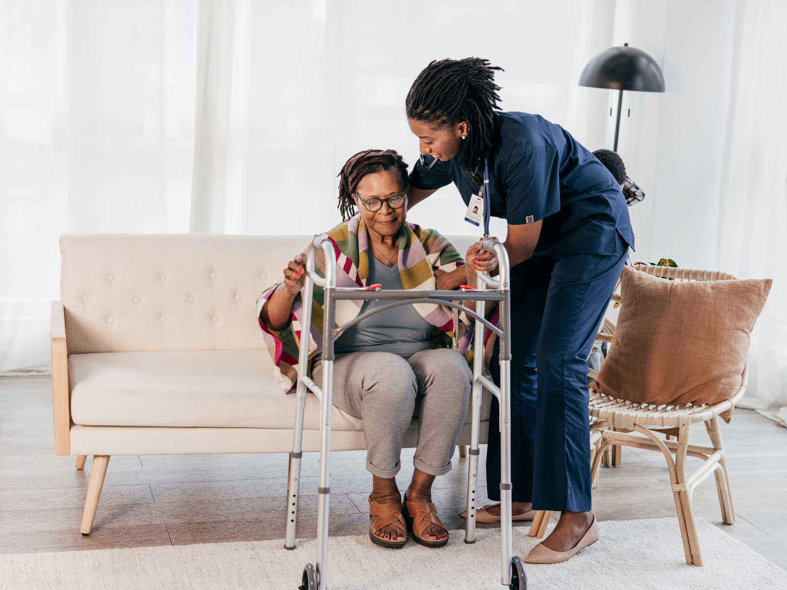 Caregiver assisting an older adult with hands-on support at home